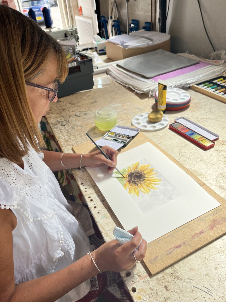 Picture of lady painting a flower